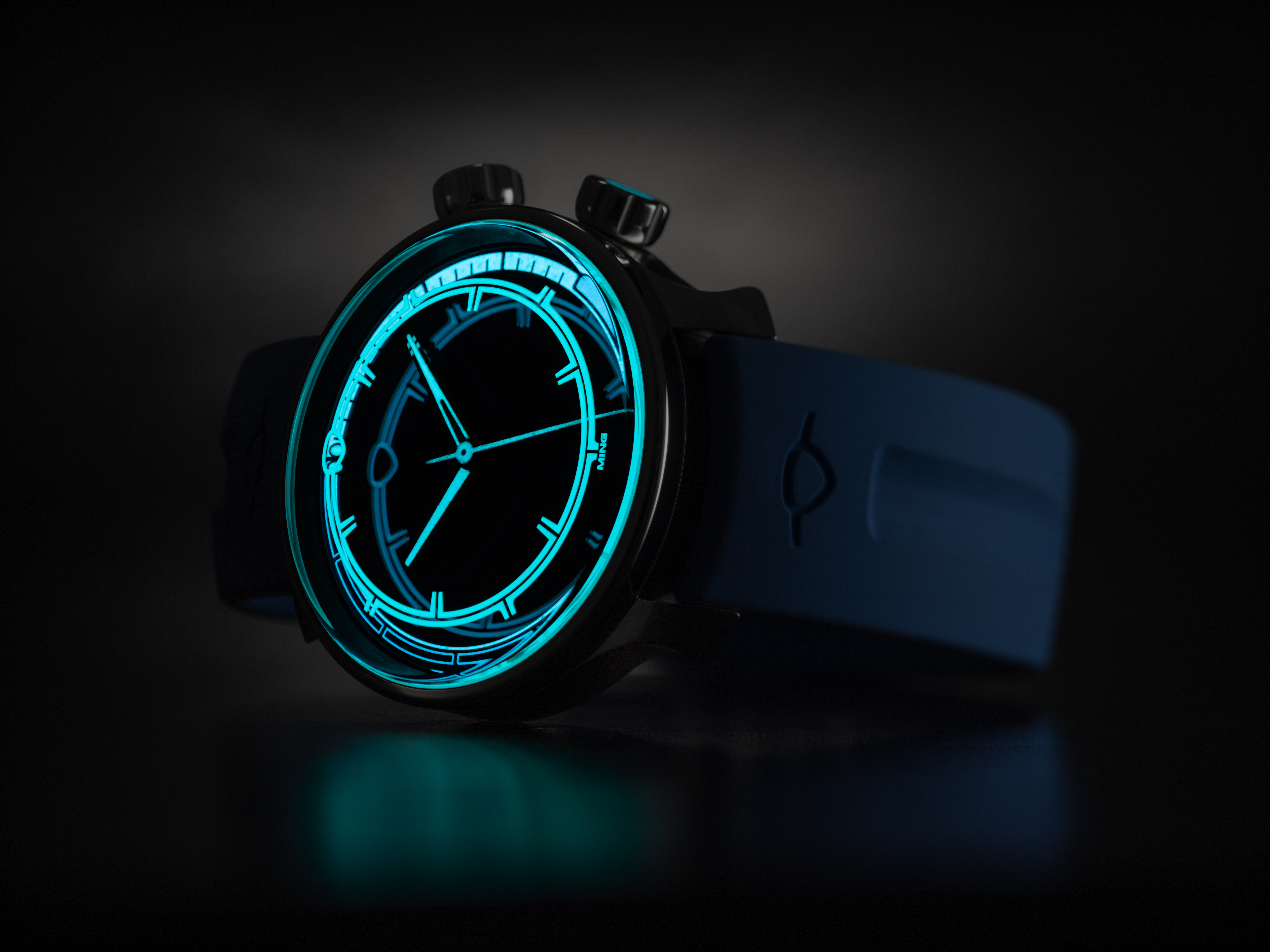 Dive watch at night with glowing Super-LumiNova X1 on dial and hands