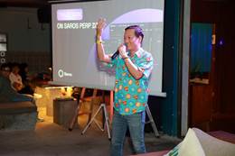 A person standing in front of a projector screen  AI-generated content may be incorrect.