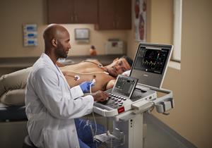 A clinician with Compact Ultrasound 5500CV and patient
