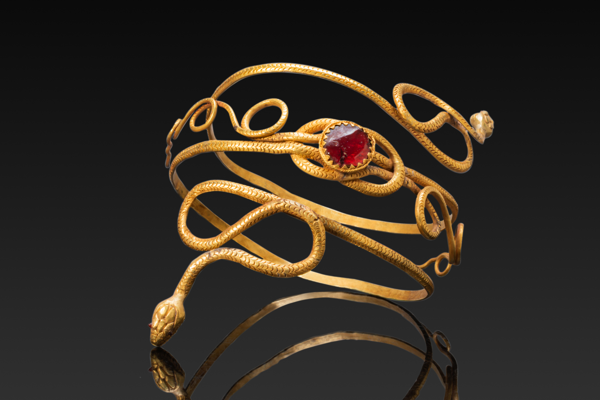 STUNNING EGYPTIAN HIGH KARAT GOLD DOUBLE SNAKE BRACELET WITH GARNETS