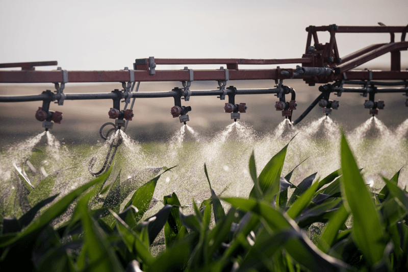 Tractor spraying Biostimulants on field. 