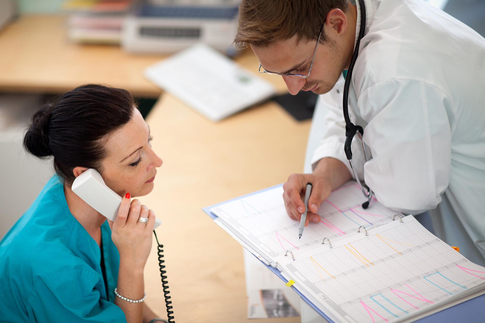 Two clinicians reviewing patient materials - 1