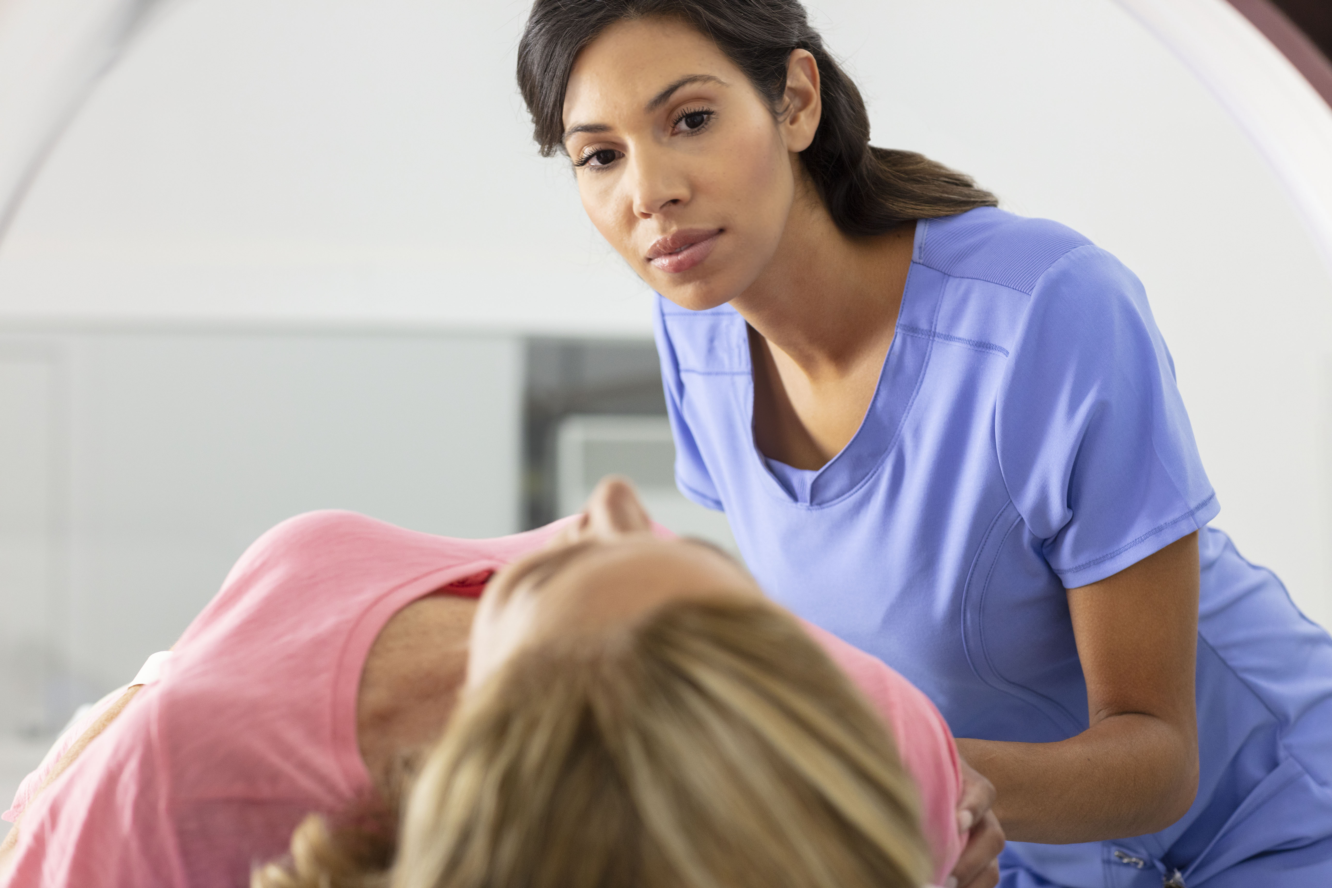 Radiology technologist guides patient