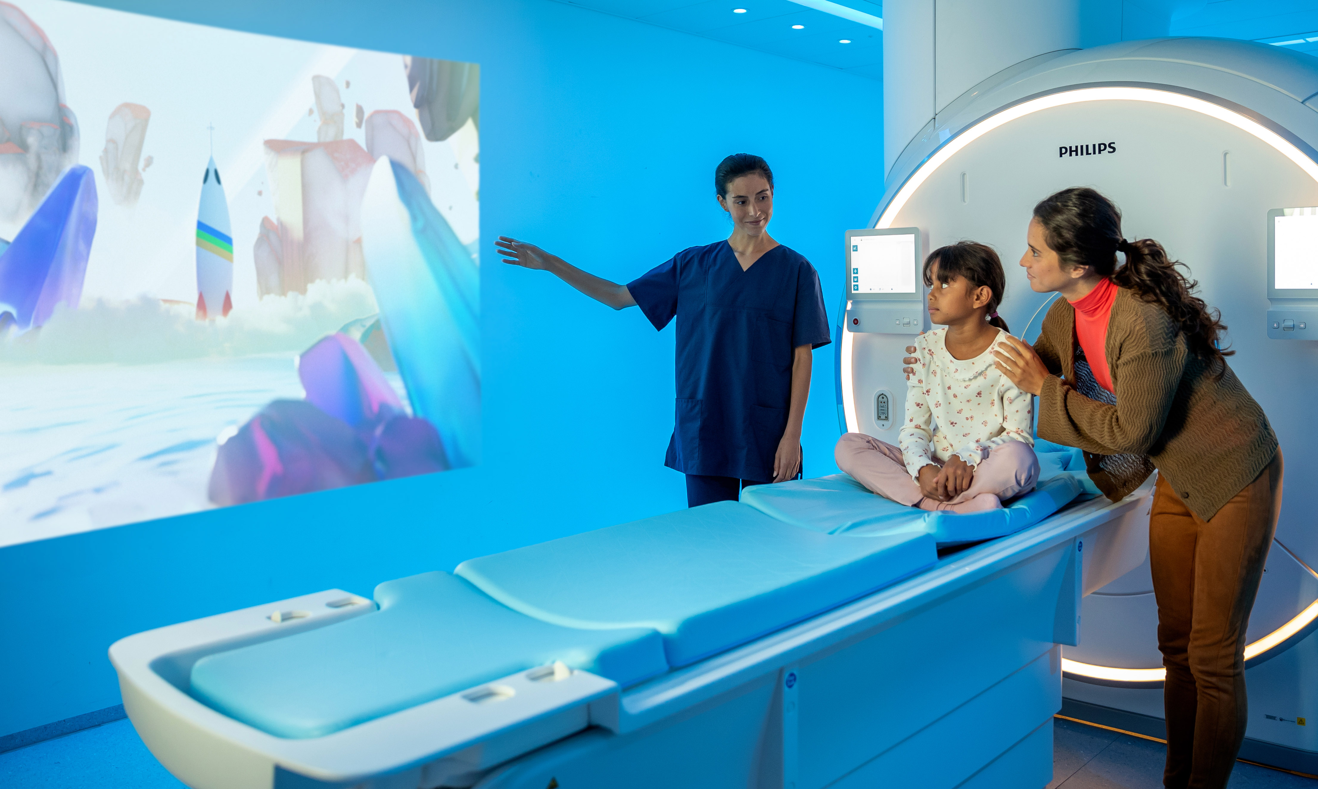 A nurse reassuring a child and mother before the MRI exam by means of Pediatric Coaching