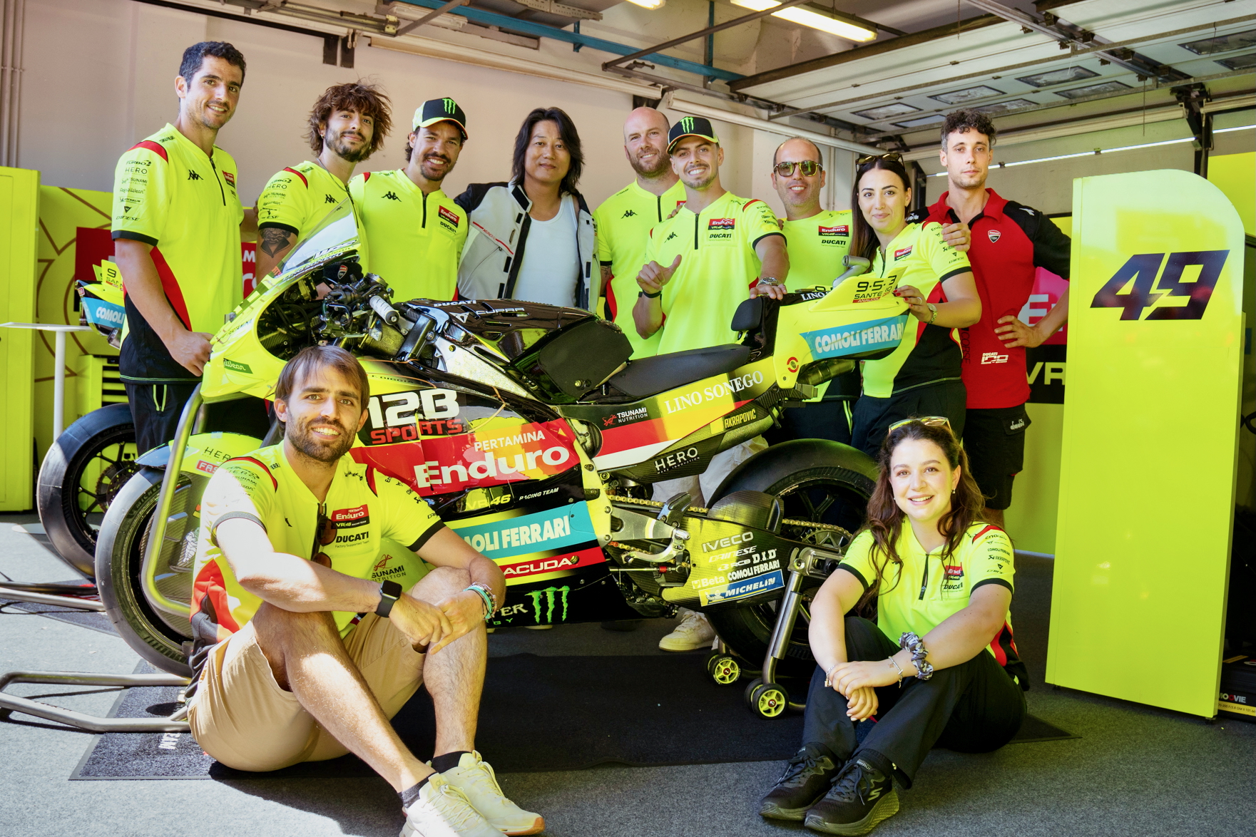 Sung Kang with the Pertamina Enduro VR46 Racing Team alongside a MotoGP race bike featuring 12B SPORTS branding