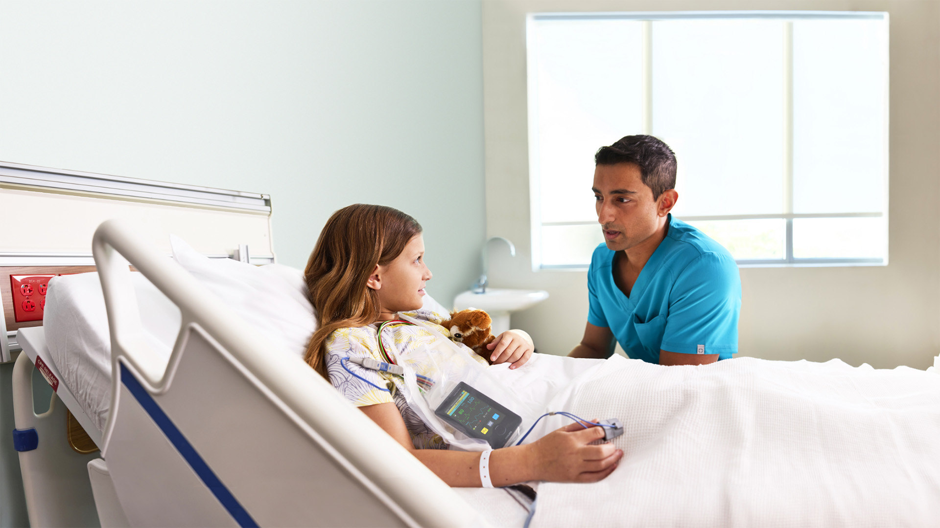 A clinician in discussion with a young patient