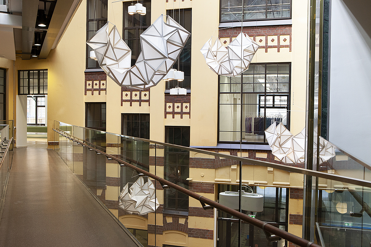 The installation is called Geo Pilvi and consists of eight folded structures that hang from the ceiling of Glasshouse Helsinki.