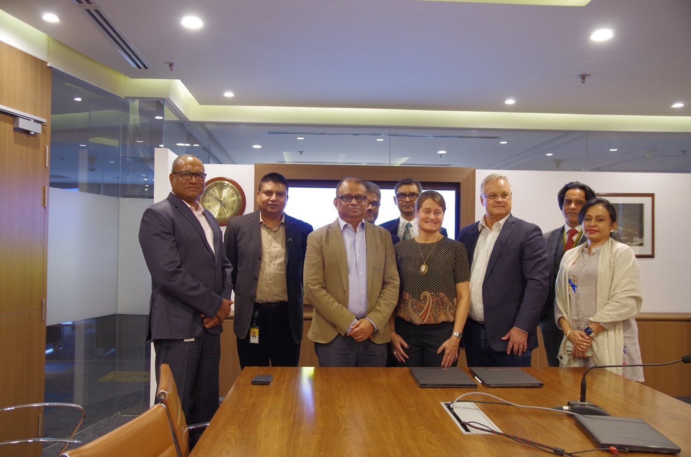 Ali Reza Iftekhar, managing director and CEO of Eastern Bank PLC, and Catharina Eklof, chief commercial officer of IDEX Biometrics, pose for photographs after signing an agreement at the bank’s head office in Dhaka.