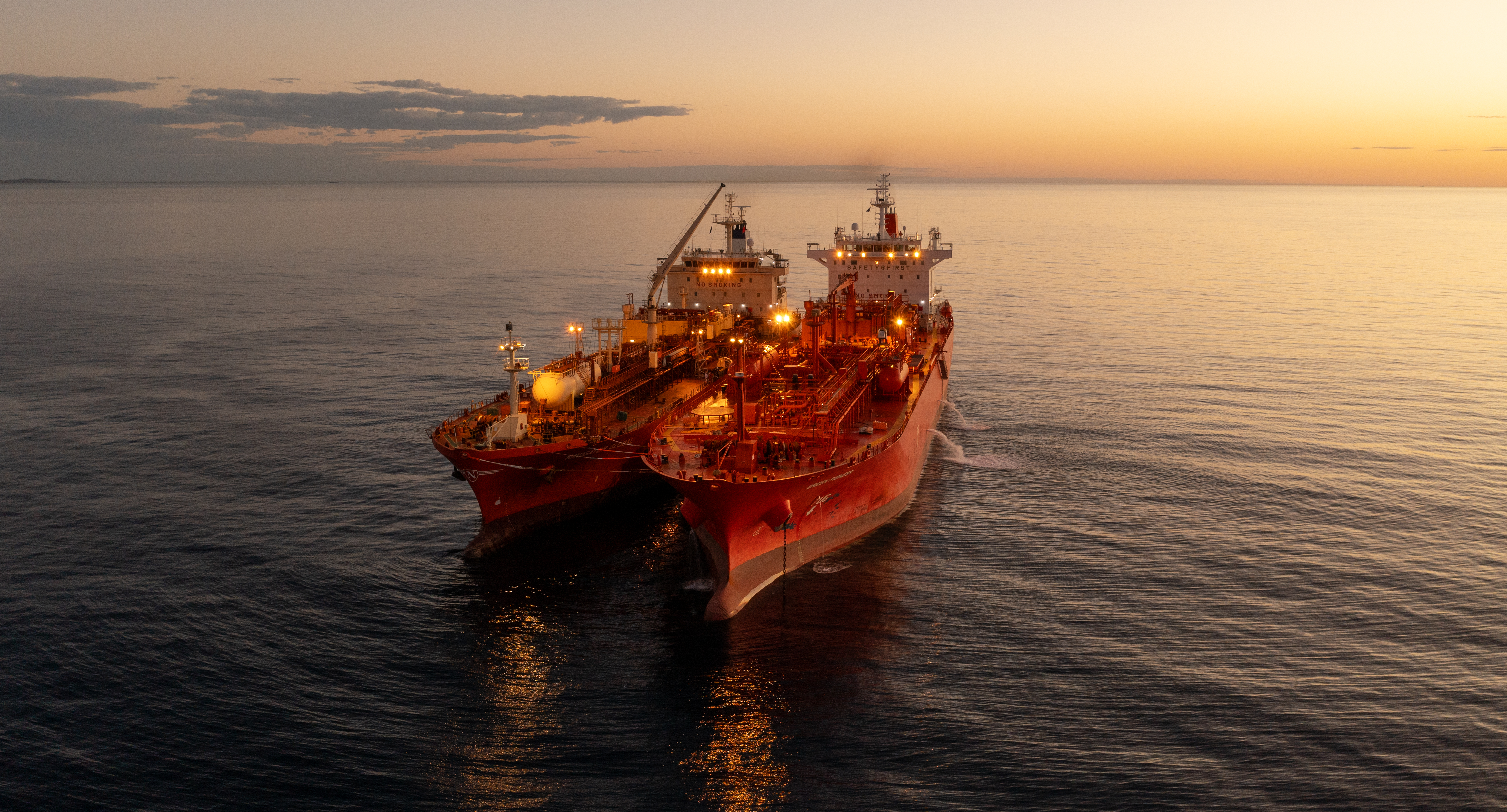 Navigator Global and the Green Pioneer at dusk at the outer anchorage of Port Dampier