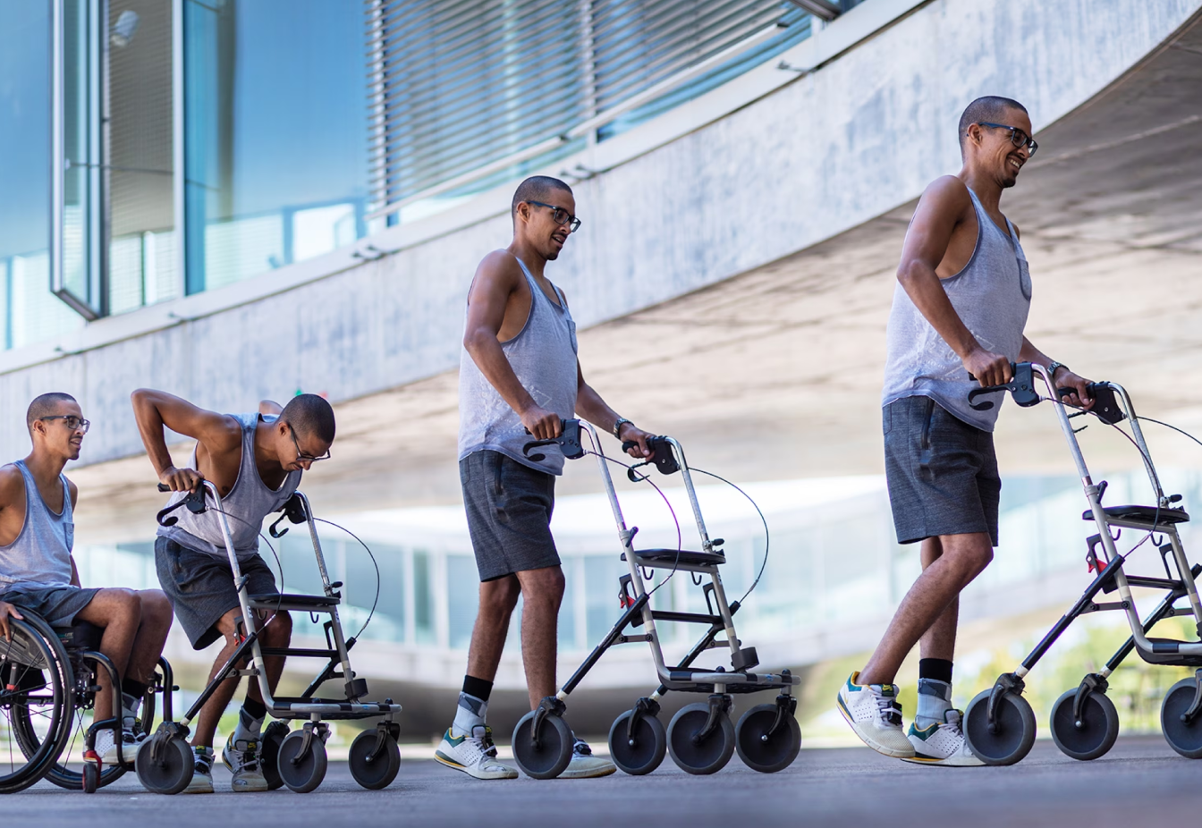 Patient transitioning from a wheelchair to walking with a walker, showcasing NeuroRestore rehabilitation powered by SciChart.