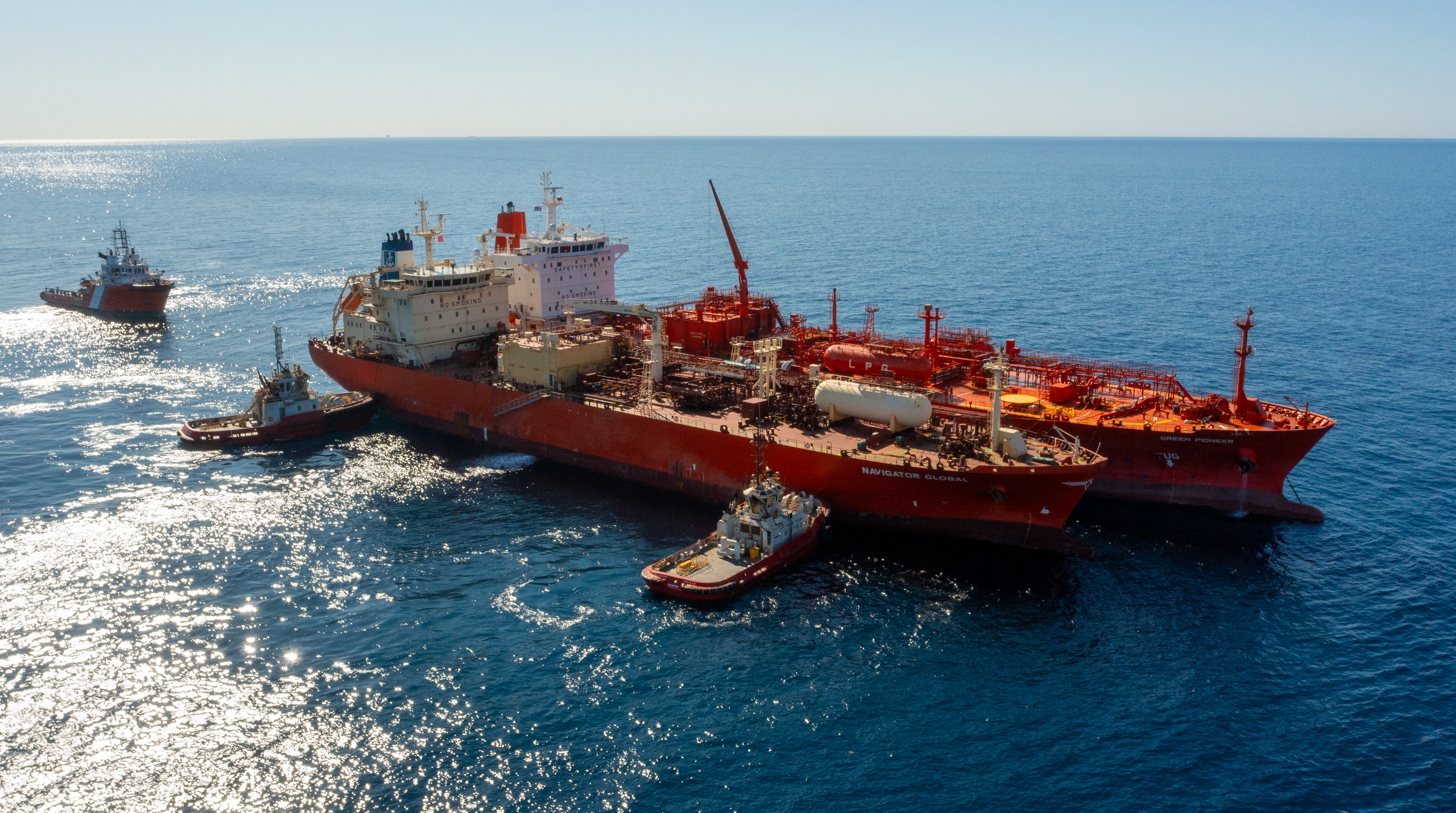 The Green Pioneer and the Navigator Global with tugboats at the outer anchorage of Port Dampier