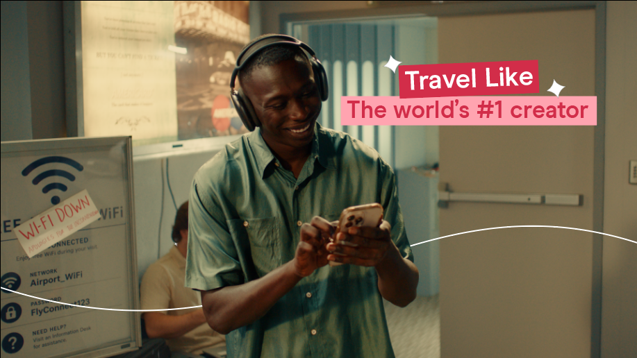 Khaby Lame using a Holafly eSIM to stay connected while travelling through an airport.