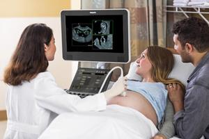 Clinician uses ultrasound in pregnancy assessment 