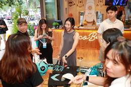 A group of people standing around a table  AI-generated content may be incorrect.
