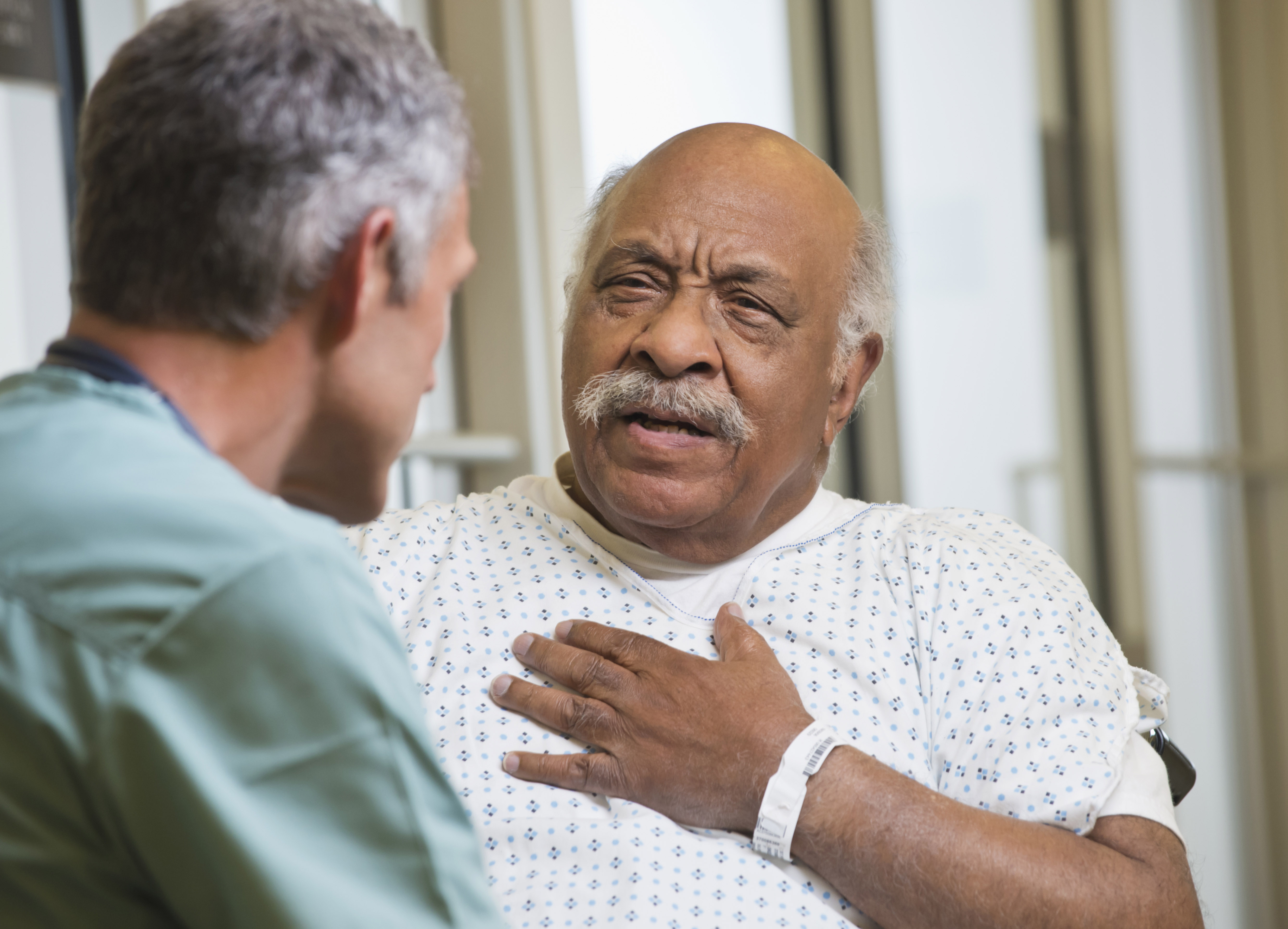 Physician talks to patient