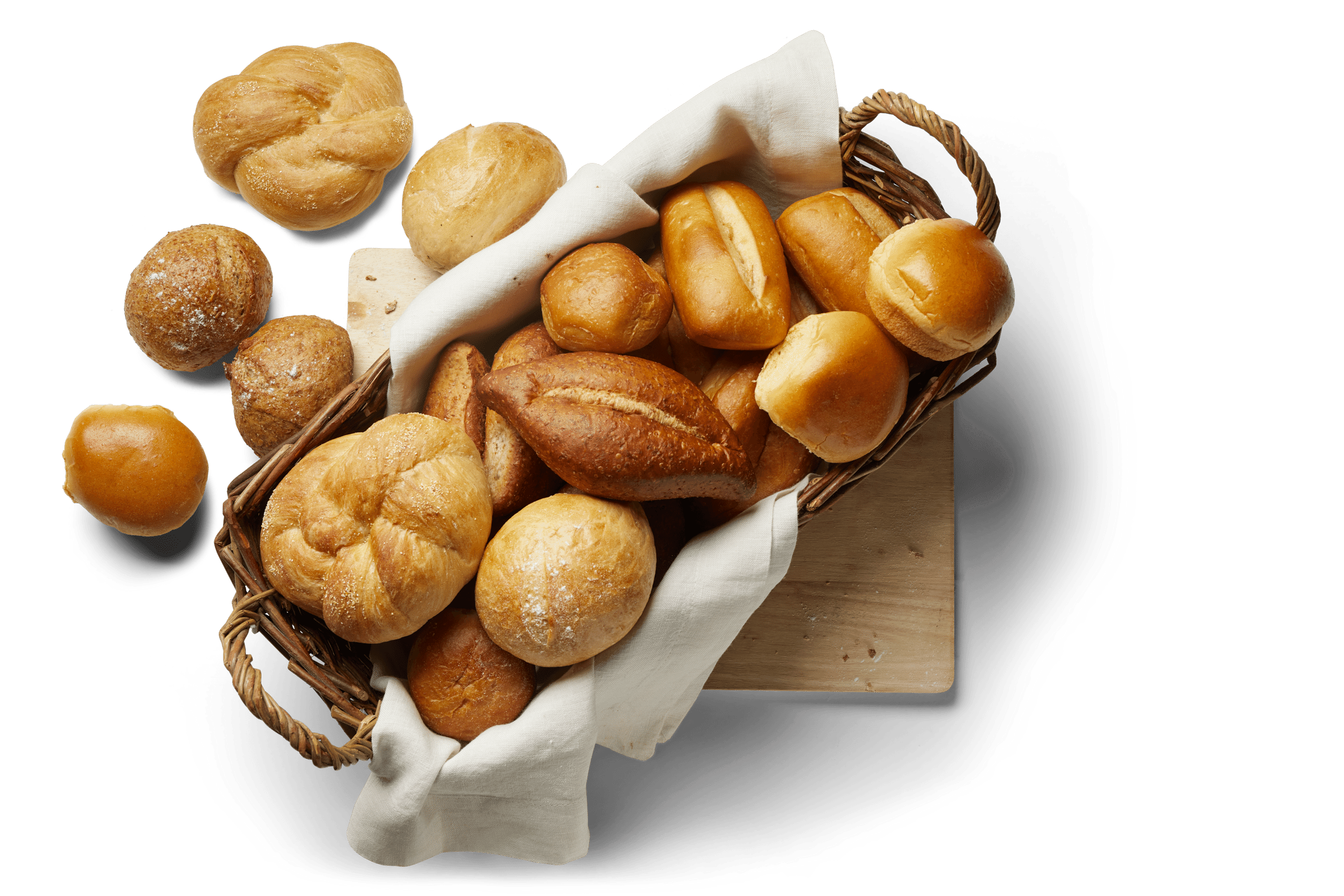 A wicker basket lined with a white cloth, filled with various types of freshly baked bread rolls, including round, knot-shaped, and oblong varieties, 