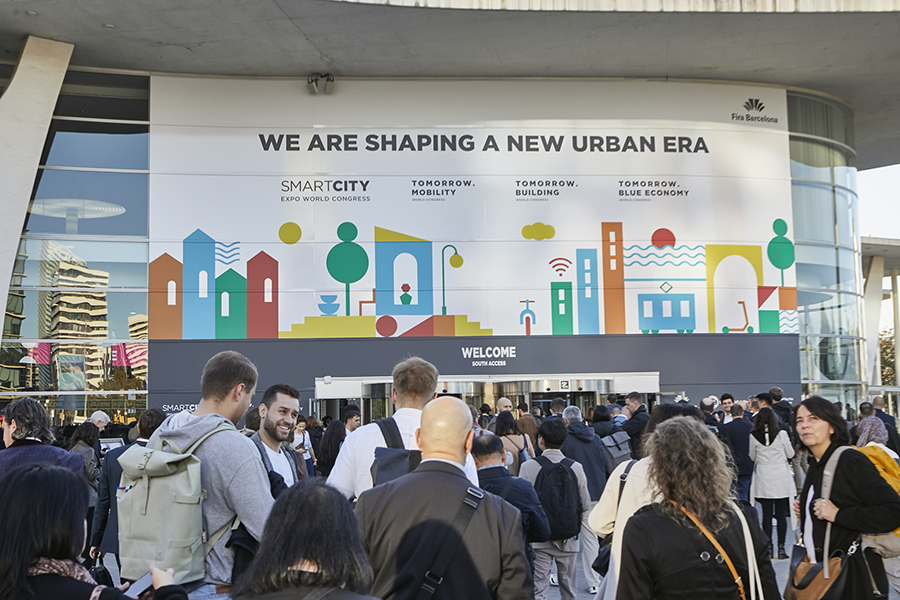 Attendees gather at the access of Smart City Expo World Congress held at Fira de Barcelona's Gran Via venue.