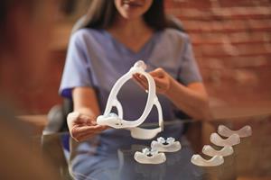 A care provider discusses mask and cushion sizing options with a patient